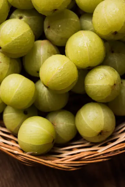 stock photo of Indian gooseberry or Amla (Phyllanthus emblica) in a cane basket, selective focus