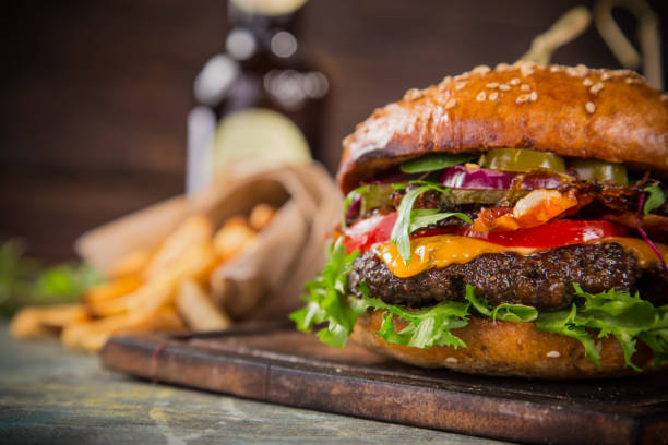 나무 테이블에 맛 있는 햄버거 - burger barbecue grill hamburger grilled 뉴스 사진 이미지