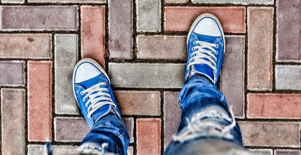 istock Legs in blue sneakers 860254030