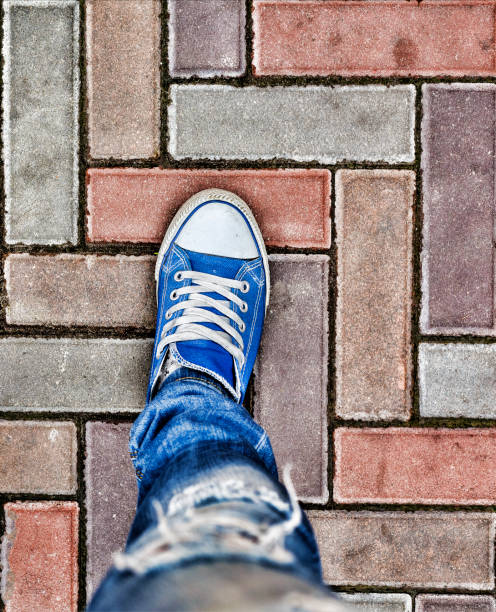 istock Legs in blue sneakers 860254344