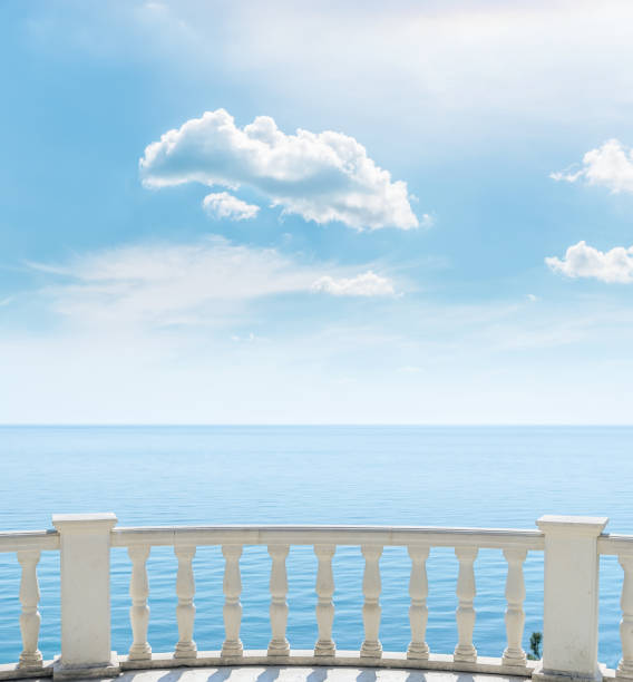 istock white balcony over sea and clouds in blue sky 860261496