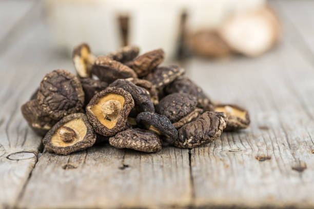 istock Wooden table with Dried Shiitake, selective focus 860267806