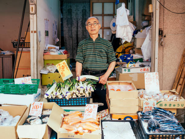 Tokyo Japan Vegetable Shop A shop owner working in his vegetable stand in Tokyo, Japan. tokyo japan photos stock pictures, royalty-free photos & images