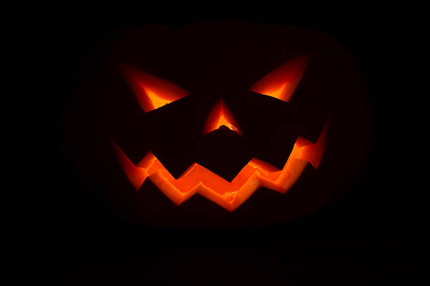 istock burning smile of jack o lantern on black background 860281954