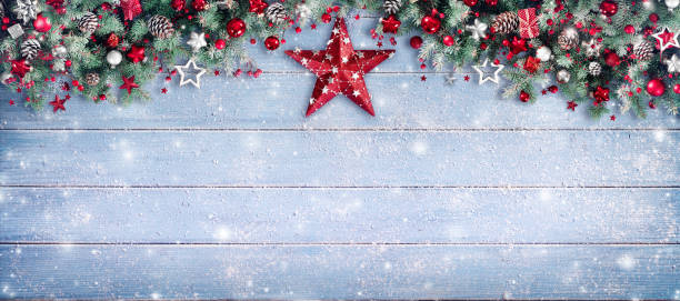 istock Christmas Border - Pine Branches And Red Star On Wooden 860282226