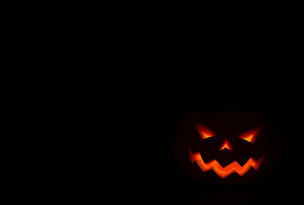 istock burning smile of jack o lantern on black background 860292396