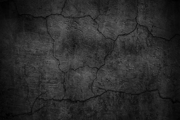 istock Black cement wall. Dark texture of cracked concrete 860296182