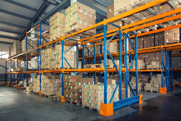 istock Rows of shelves with boxes in big modern warehouse 860299858