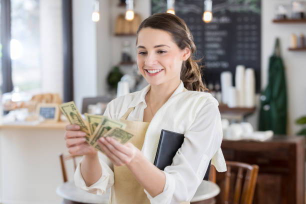 Happy waitress is pleased after receiving a large tip