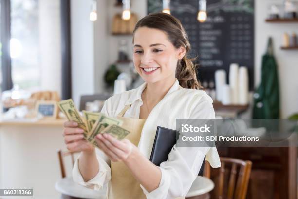 Happy Waitress Is Pleased After Receiving A Large Tip Stock Photo - Download Image Now