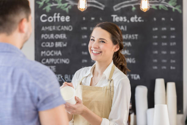 istock Cheerful barista takes unrecognizable customer's order 860318382