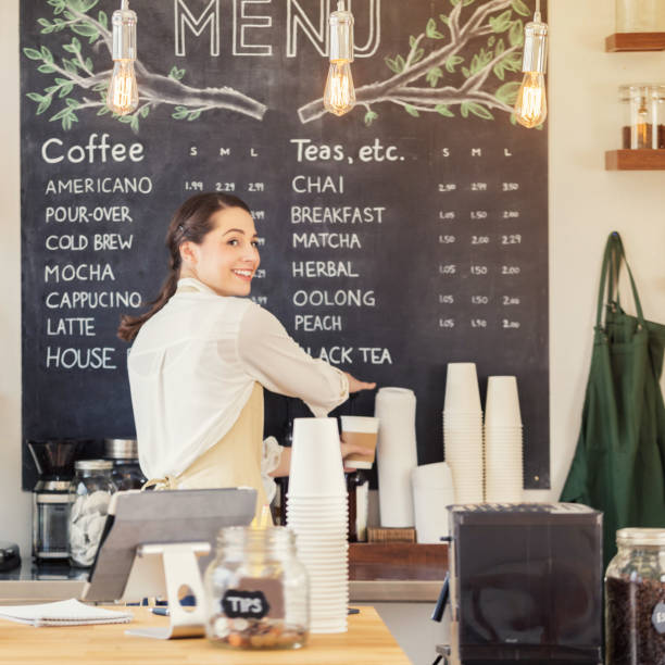 istock Confident female barista works on coffee order 860318396