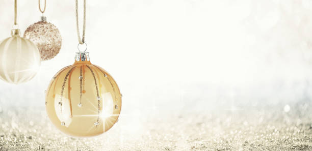 istock Hanging Christmas Ornaments over Bokeh Background 860318900