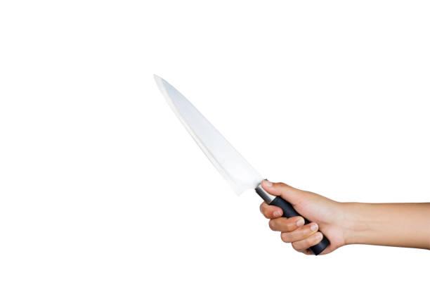 istock A female hand holding knife isolated on white background with clipping path. 860319122