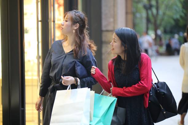 istock Two young women shopping in city 860319420
