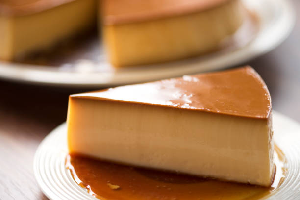 istock Homemade caramel custard pudding on white plate stay on wood table 860334748