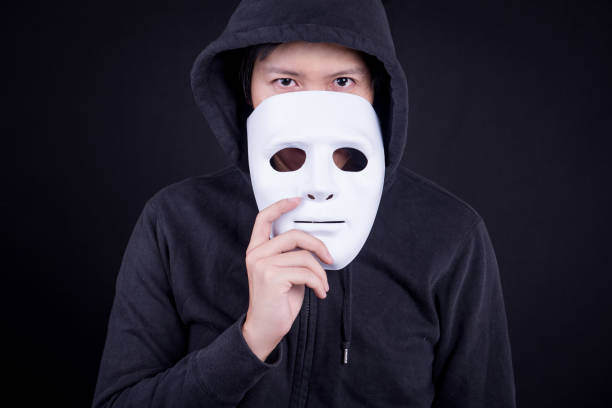 istock Mystery man holding white mask for hide his face 860337962