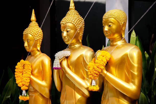 istock Golden Standing Buddha Statues in a Row. 860345858