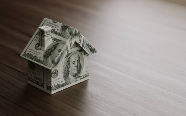 istock Tiny House Model Textured With One Hundred American Dollar Banknotes On Brown Wood Surface 860355406