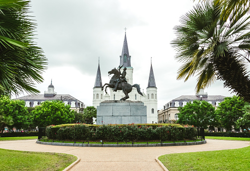 New Orleans, Louisiana, USA - June 25, 2017: Jackson Square, Saint Louis Cathedral and the statue of President Jackson - the landmarks of the French Quarter in New Orleans, Louisiana, USA. Tourist attraction of New Orleans. City after a warm tropical rain. Modern urban life in New Orleans