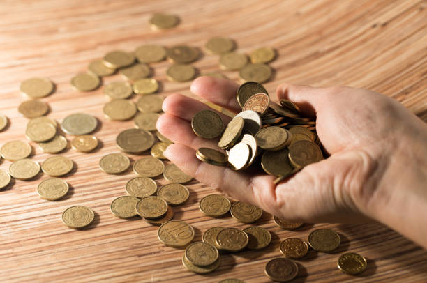 istock coins on the table and in hand 860362392