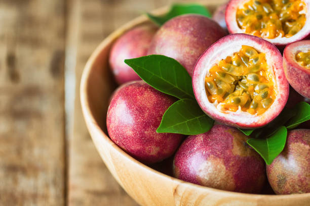 istock Close up fresh passion fruit in wood bowl on wood table in side view with copy space for background or wallpaper. Ripe passion fruit so delicious sweet and sour. Tropical fruit. Macro concept. 860363178
