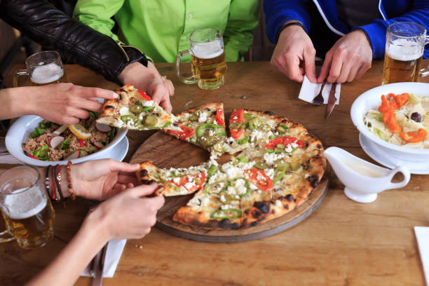 istock Friends eating pizza in restaurant 860369638