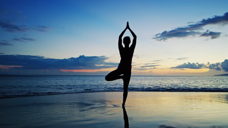 Woman Practicing Yoga at Sunset