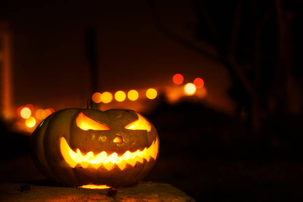 istock Spooky jack o' lantern against bokeh lighting 860373086