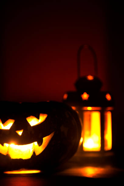 istock Lantern with candle and scary pumpkin 860373358