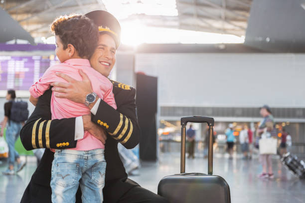 空港で父航空従事者を会議の小さな男の子 - embracing smiling gap children only ストックフォトと画像