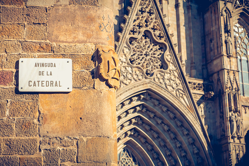 marble street sign where it is written in Spanish - Avenue of the cathedral