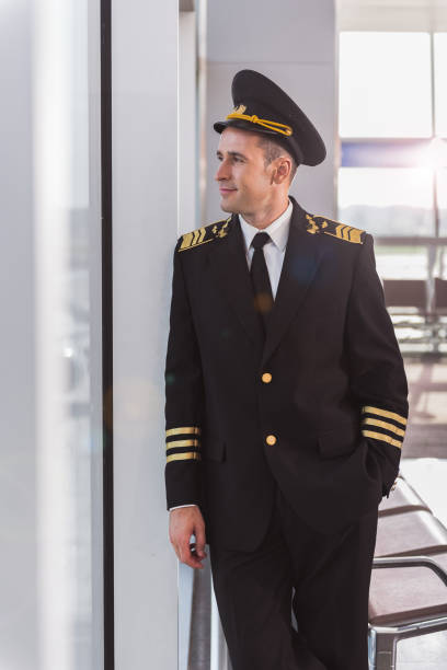 istock Cheerful smiling adult airman glancing though window 860378800