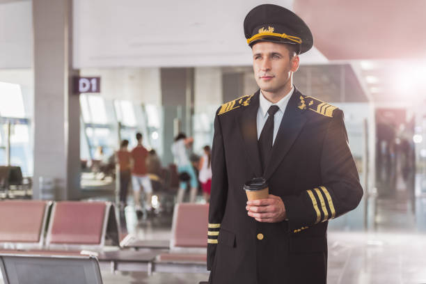 istock Thoughtful airman holding cup of coffee 860381592