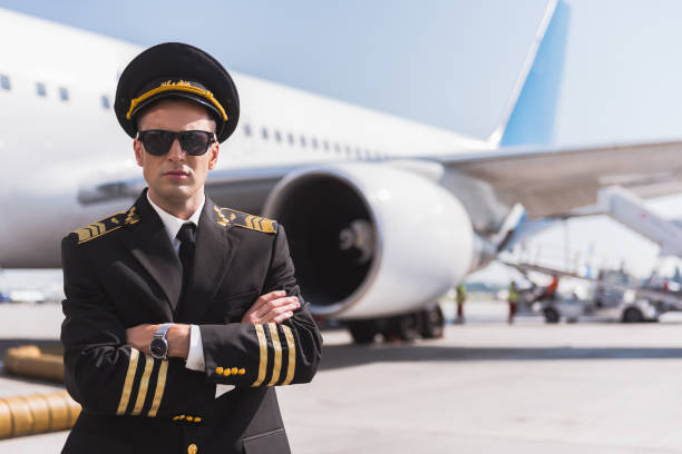 istock Serious aviator locating near plane 860384146