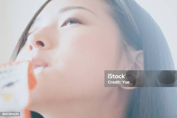 Woman Drinking Juice With A Straw Stock Photo - Download Image Now - Women, Smiling, Japan