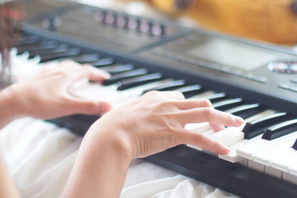 Woman's hand playing the electronic piano at home