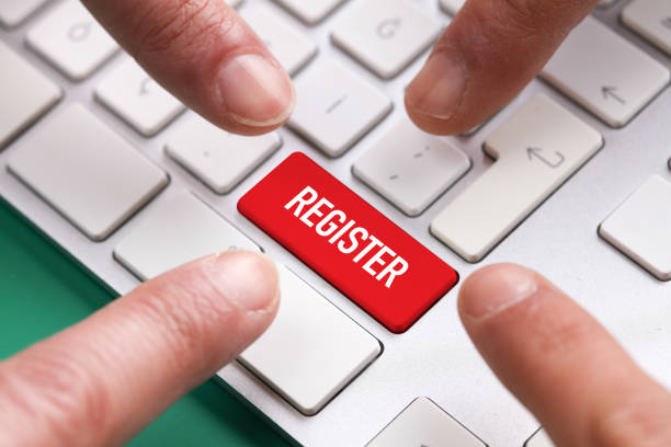 istock Computer Keyboard Concept: Many fingers pushing red REGISTER keyboard button 860387660