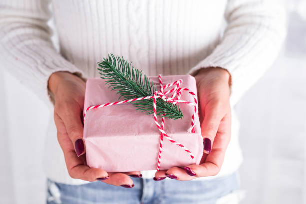 istock Woman's hands hold christmas gift box. 860388054