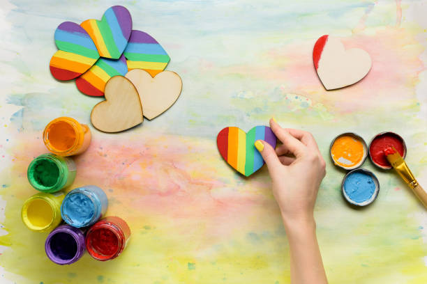 istock Hands holding handmade lgbt hearts 860388848