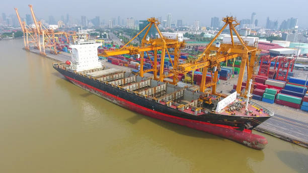 istock Logistics and transportation of Container Cargo ship and Cargo working crane bridge in shipyard 860388996