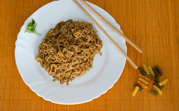 istock Noodles with beef in plate with bamboo stic 860389982