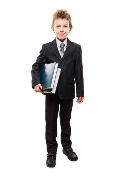 uśmiechnięty chłopiec dziecko w garniturze biznesowym trzymając książki - book holding necktie businessman zdjęcia i obrazy z banku zdjęć