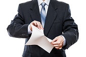 Angry businessman hand tearing paper document