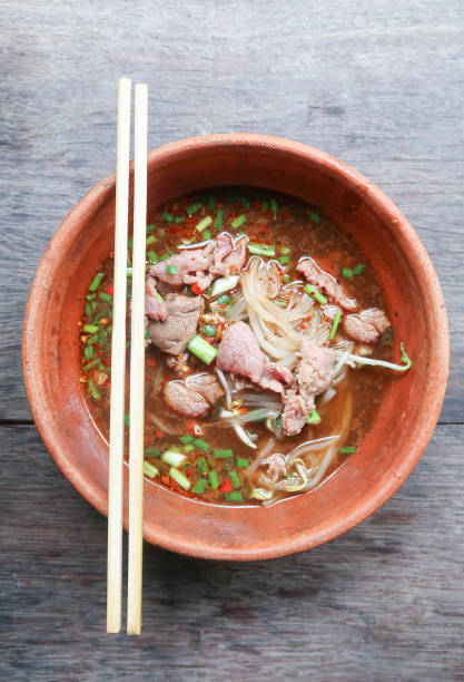 istock Noodle soup with beef on wood background 860396506