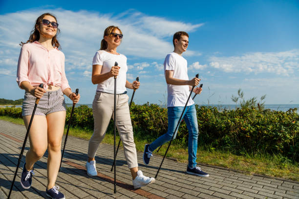 海辺でノルディック ウォーキング向けトレーニング - nordic walking walking relaxation exercise women ストックフォトと画像