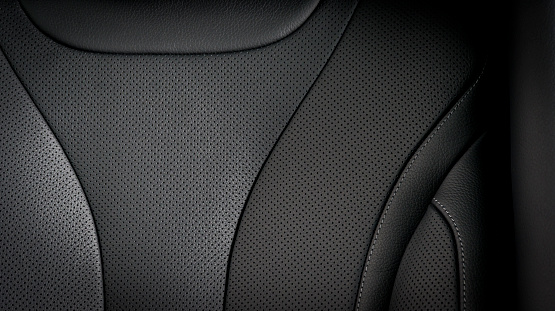 Part of  leather car seat details. Black perforated leather.