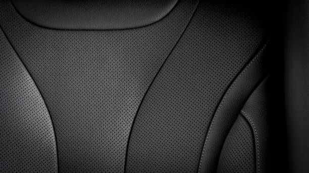 Part of  leather car seat details Part of  leather car seat details. Black perforated leather. saloon car stock pictures, royalty-free photos & images