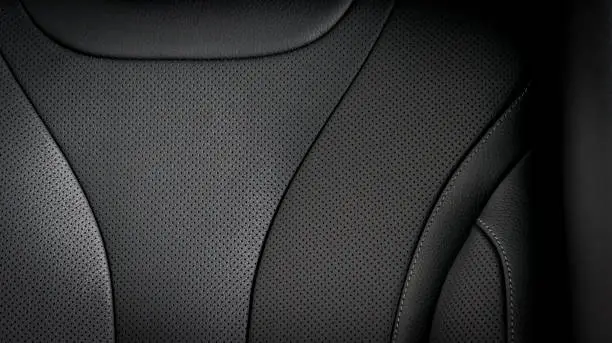 Part of  leather car seat details. Black perforated leather.