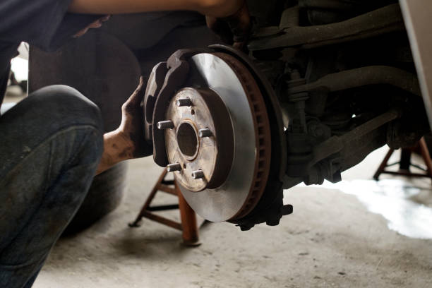 istock Beside of technician are maintenance working front wheel in garage. 860406908